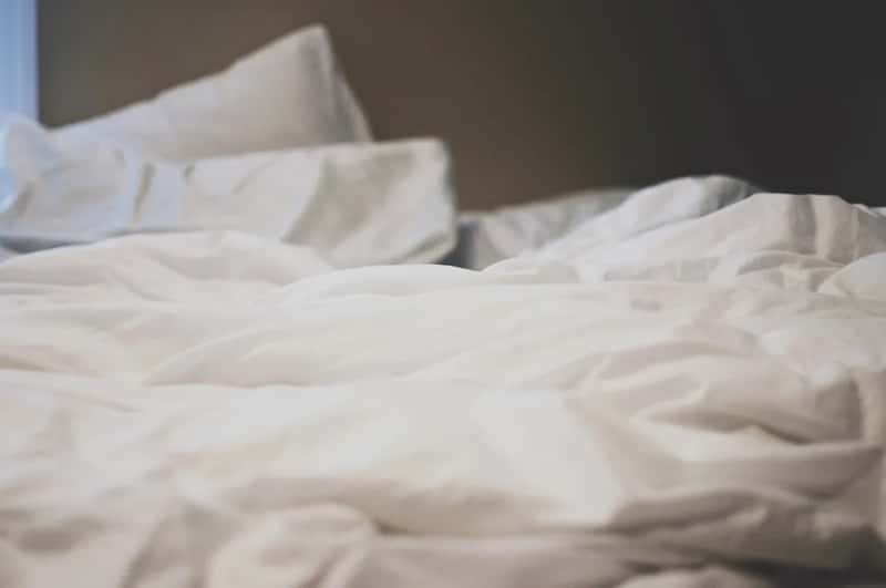 1. That Decorative Bedspread Probably Hasn't Been Washed in Weeks (Image Credits: Unsplash)