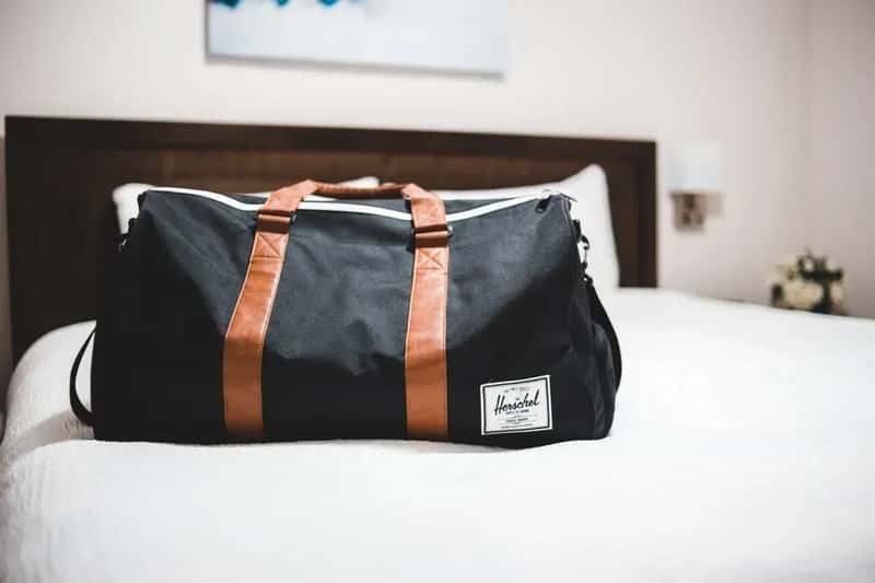 1. Putting Your Luggage on the Bed the Moment You Walk In (Image Credits: Pexels)