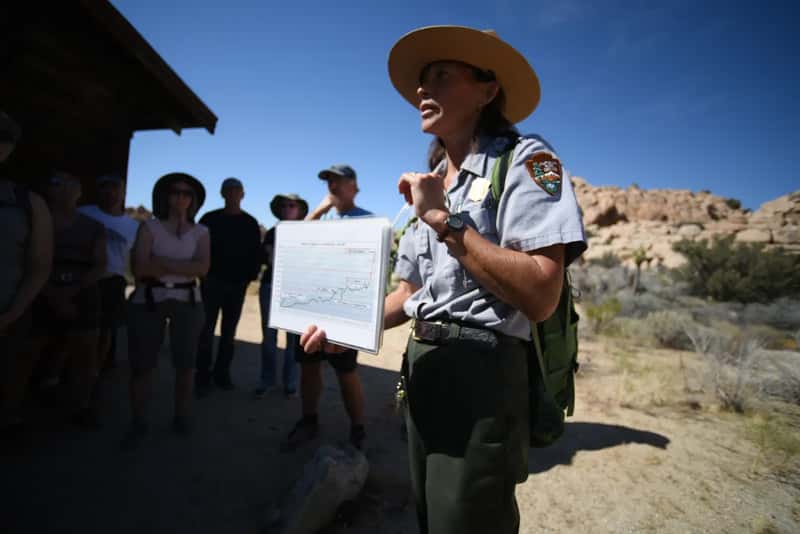 Mistake #1: Treating a National Park Like a City Park (Ranger with park visitation statistics, Public domain)