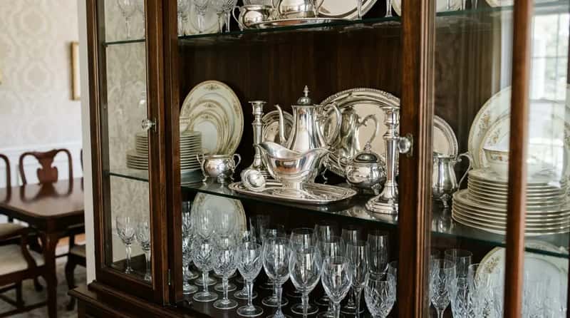 #4 - The Breakfront Display Cabinet Showing Off Silver and Crystal Nobody Ever Used (Image Credits: Gemini)