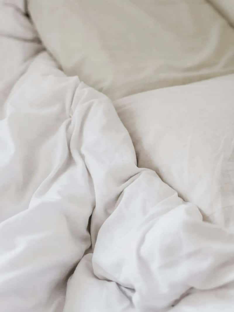 The comforter on the bed might not have been washed in a long while (Image Credits: Unsplash)