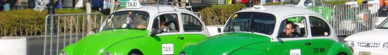 Taxis, Rideshares, and Airport Transfers (This file was derived from:  Taxis in Mexico City.jpg:, CC BY-SA 2.0)