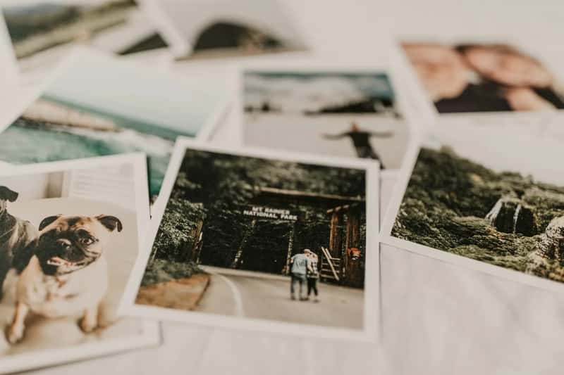 4. Printed photographs or a small photo album (Image Credits: Unsplash)
