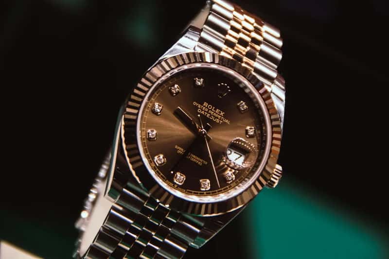 Wearing jewelry, watches, and other visible signals of wealth (Image Credits: Unsplash)