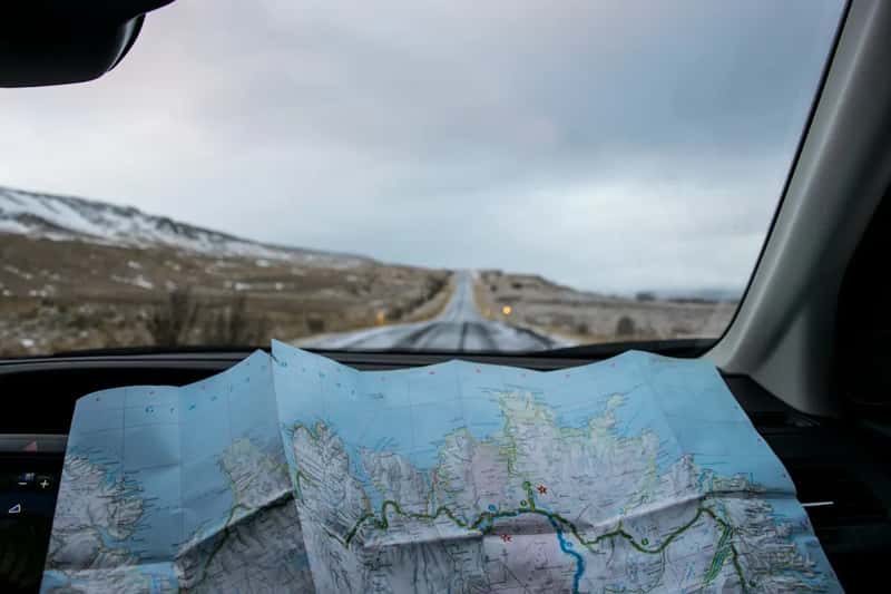 Navigating entirely by paper road maps (Image Credits: Unsplash)