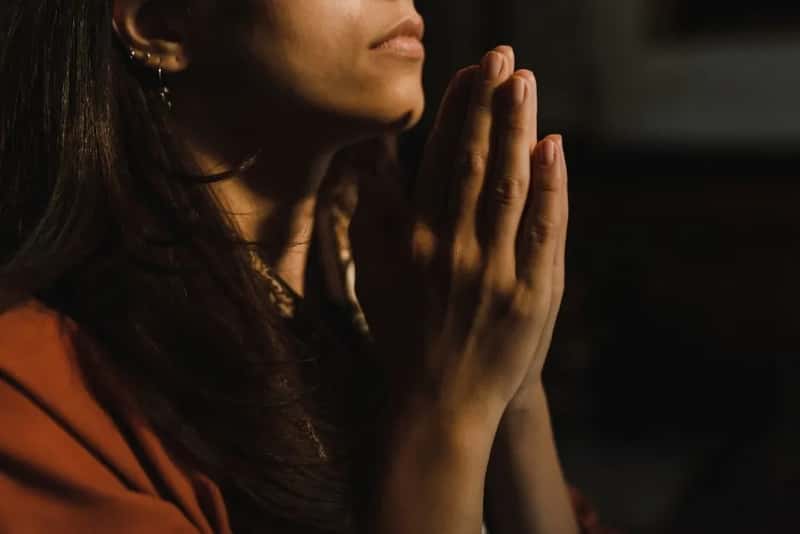 3. Praying before hitting the road (Image Credits: Pexels)