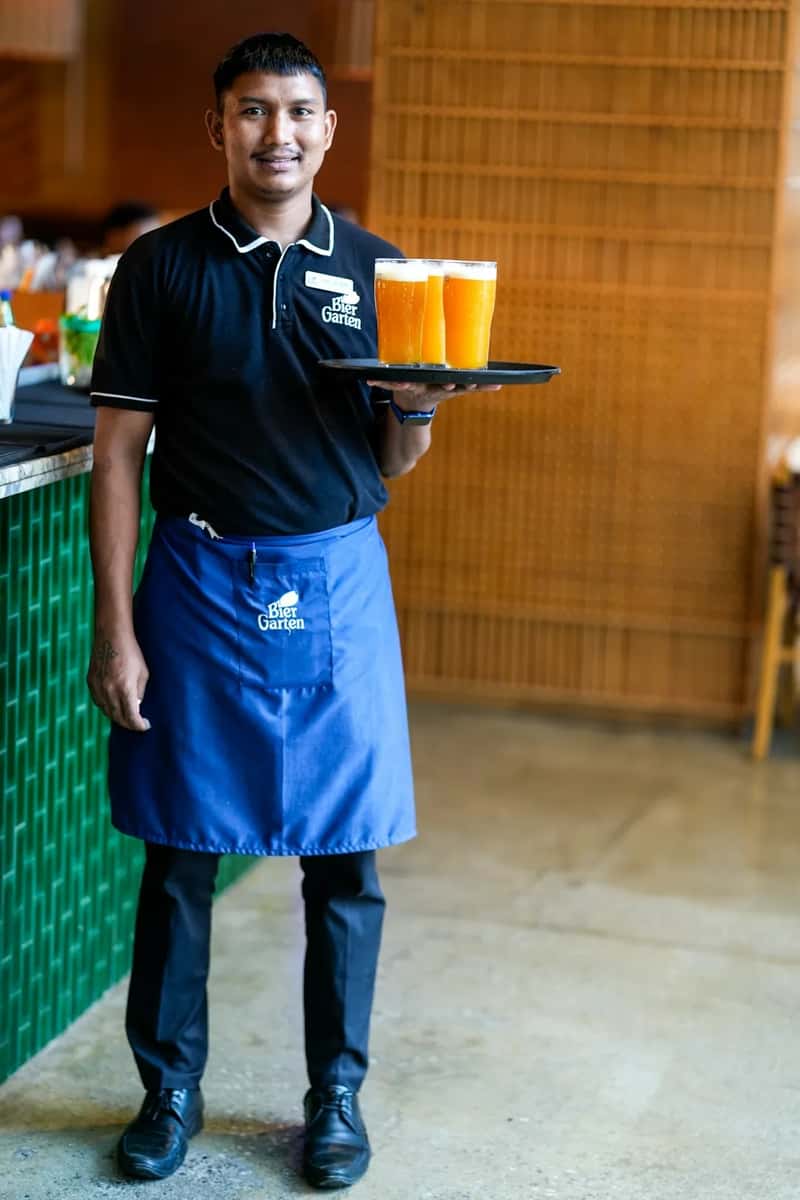 3. Grabbing food or drinks off a server's tray (Image Credits: Unsplash)