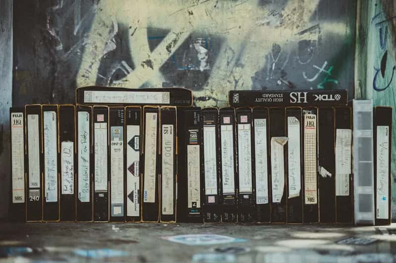 #25 - VHS Tapes With Handwritten Labels Stacked in Towers Near the TV (Image Credits: Unsplash)