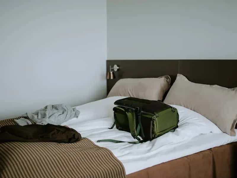 1. Putting Your Luggage on the Bed the Moment You Walk In (Image Credits: Unsplash)
