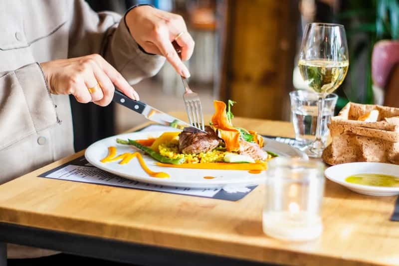 Eating alone in a restaurant (Image Credits: Unsplash)