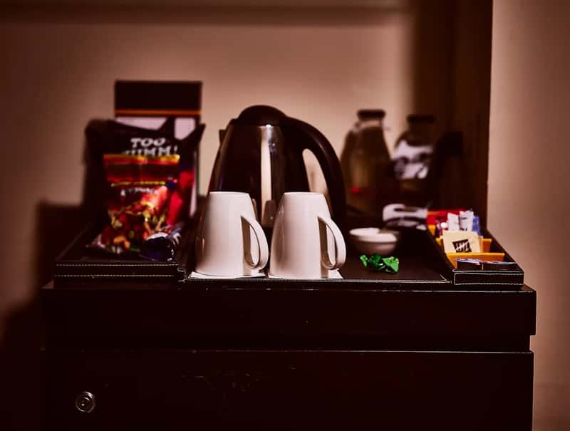 Treating the minibar like a free snack shelf (Image Credits: Unsplash)