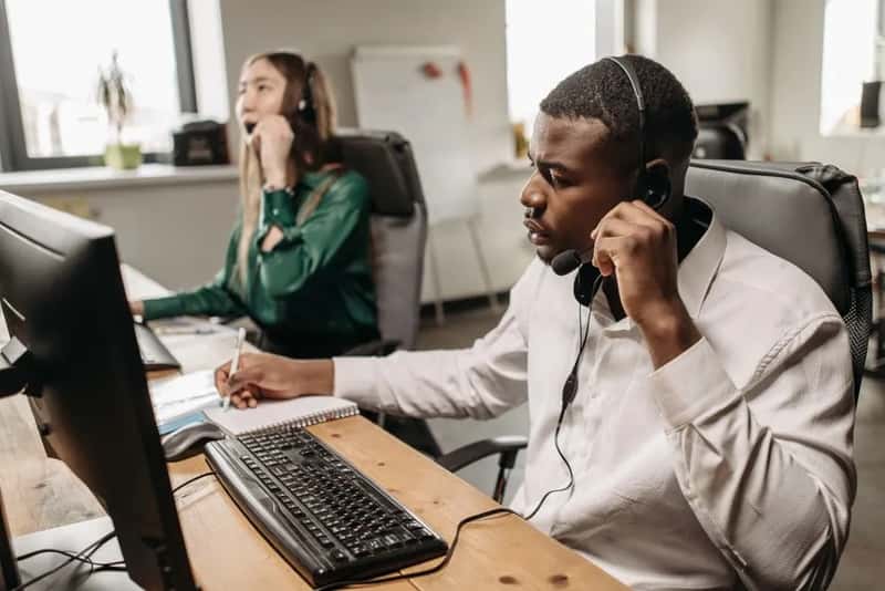 4. Phone and call center booking fees (Image Credits: Pexels)