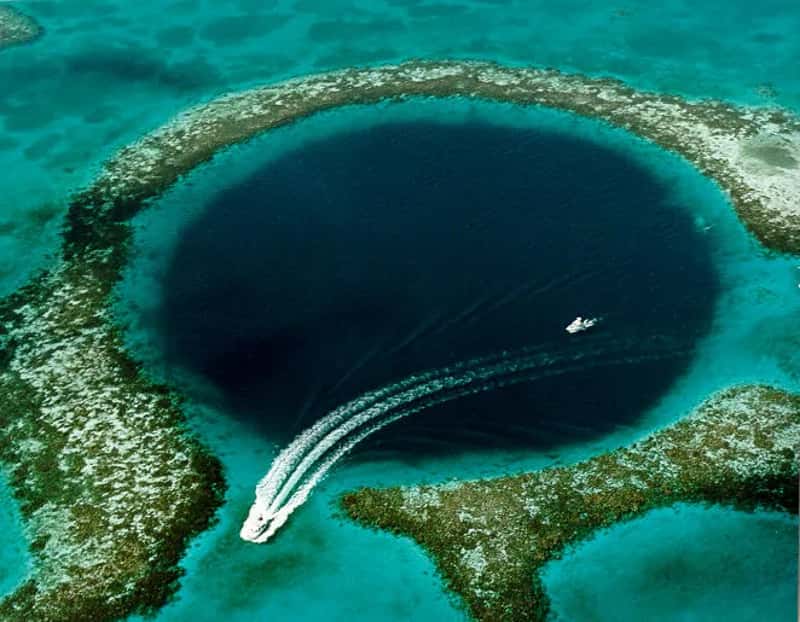 Belize holds its own with marine tourism (Source: [1], fetched September 2006. Caption on this USGS web page was, "Blue Hole: Aerial view of the 400-ft-deep oceanic blue hole (Lighthouse Reef Atoll Blue Hole) located east of Belize.", Public domain)