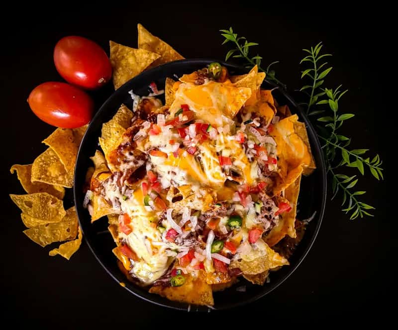Loaded pizza and cheese heavy nachos (Image Credits: Unsplash)