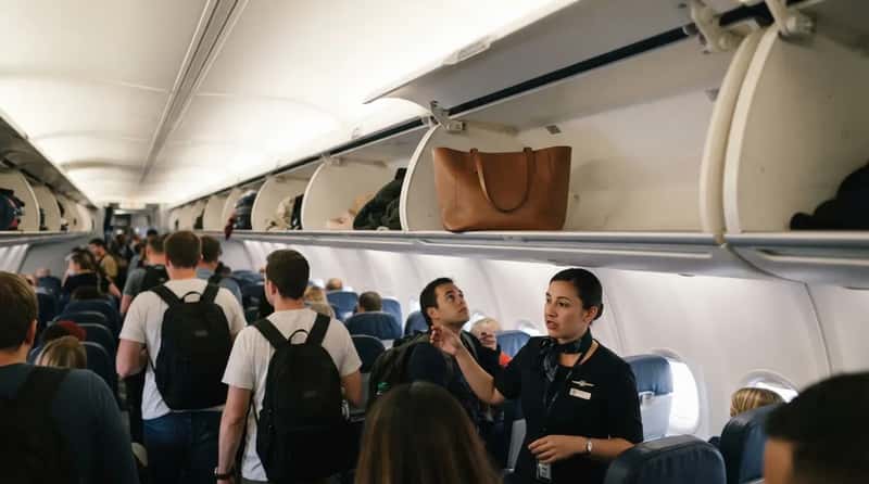 #24 - The Personal Item Parked Overhead Before the Suitcases Arrive (Image Credits: Gemini)