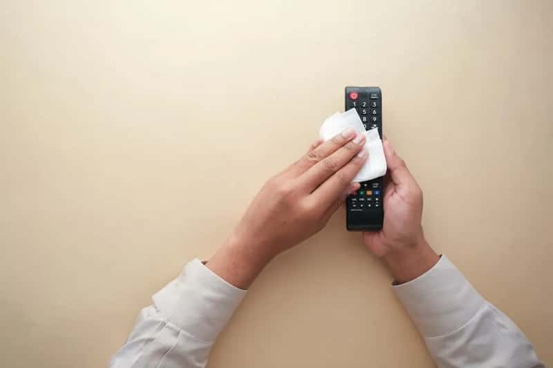 3. Wiping down high-touch surfaces with a personal sanitizing wipe (Image Credits: Pexels)