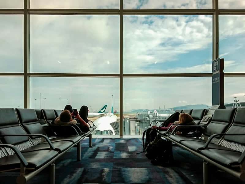 4. Spreading out across multiple seats with bags, coats, and food (Image Credits: Unsplash)