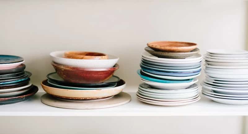 3. Piling plates into towering, unstable stacks (Image Credits: Unsplash)