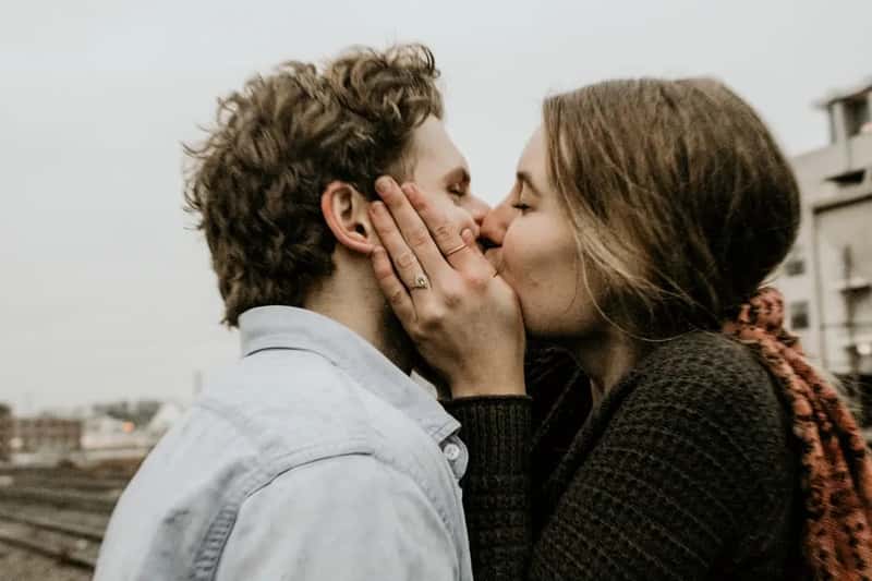 Showing affection in public, like kissing or hugging (Image Credits: Unsplash)