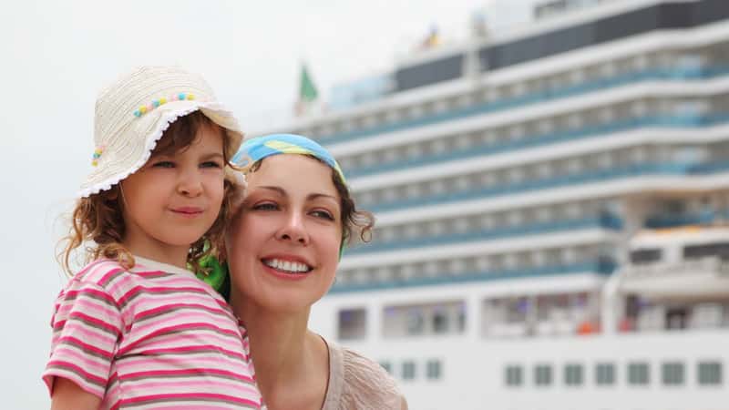 mother and daughter in dock, big cruise ship on background