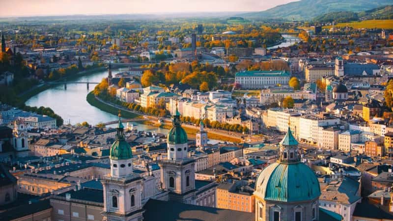 Beautiful of Aerial panoramic view in a Autumn season at a historic city of Salzburg with Salzach river in beautiful golden evening light sky and colorful of autumn at sunset, Salzburger Land, Austria