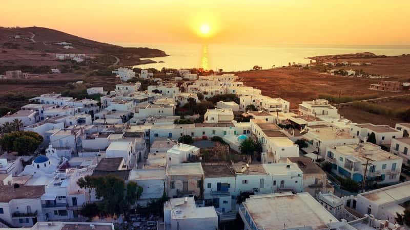 Aerial drone photo of famous Venetian fortified castle of main village in Antiparos island at sunset overlooking Sinfneiko beach, Cyclades, Greece 