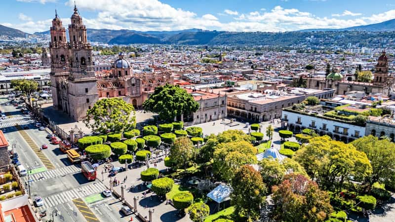 Captured from above, the Morelia Cathedral beside the lively Plaza de Armas, dotted with trees in Mexico