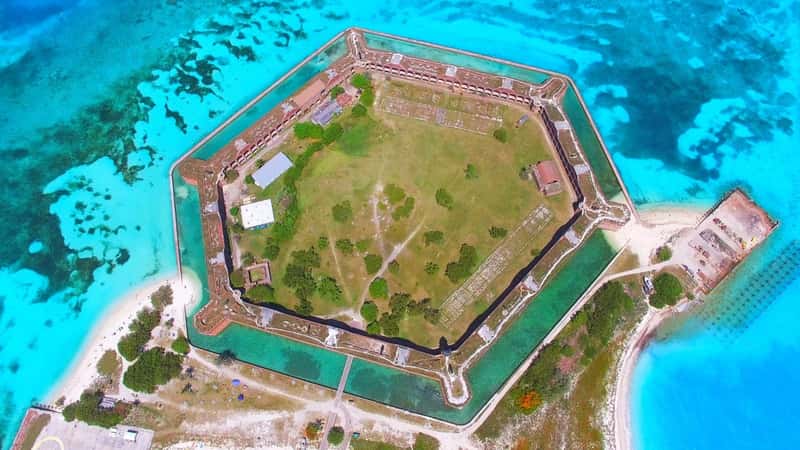 The fort stands prominently amidst the ocean, highlighting its strategic coastal location. The composition emphasizes the architectural details of the coal structure, showcasing its historical significance within the park. Surrounding the fort is the vast expanse of the ocean.