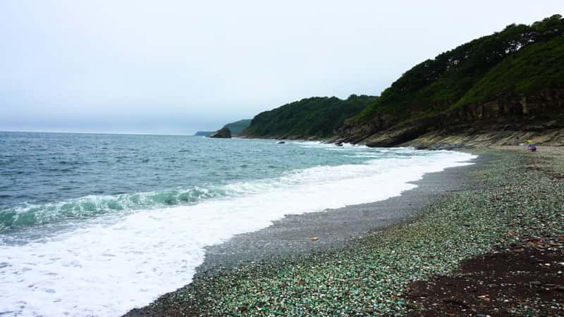 Vladivostok’s Glass Beach, also known as Steklyashka Beach, features a shoreline covered in smooth, colorful glass pebbles. The glass fragments, polished by the sea, create a mosaic of vibrant colors like green, blue, and amber.