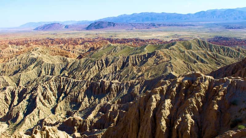 The image showcases eroded sandstone rocks and sediments in rural badlands, captured at Fonts Point in Anza Borrego State Park, CA. The scene features a rugged landscape characterized by the natural erosion of sandstone formations over time. The earthy tones of the rocks and sediments blend harmoniously with the arid surroundings typical of desert regions.