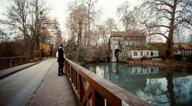 A couple admiring the view on a bridge overlooking the Loire River in Orleans France on an overcast autumn day.