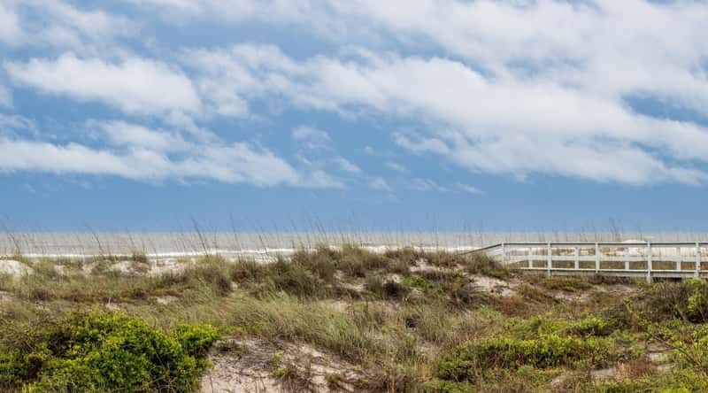 A photograph capturing Butler Beach in St. Augustine, Florida. The image features a typical coastal scene with sandy shores and the Atlantic Ocean in the background. 