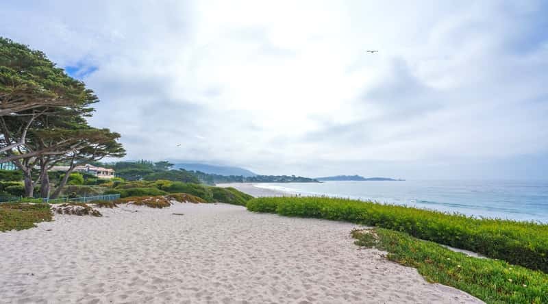 Carmel Beach is a picturesque public beach located in the coastal town of Carmel-by-the-Sea in California, USA. The beach is known for its soft white sand and clear blue waters, as well as stunning views of the rugged coastline and nearby Carmel Bay. Carmel Beach is surrounded by scenic walking paths and nature trails that offer stunning views of the ocean and nearby cypress trees.
