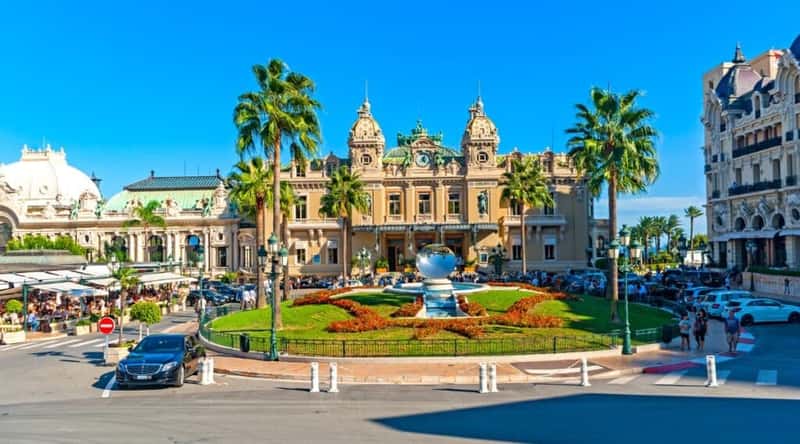 Image of Casino Square in Monaco, French Riviera. The photograph showcases the prominent public space surrounded by iconic Monte Carlo Casino. Casino Square is a central attraction known for its opulent ambiance and architectural significance.