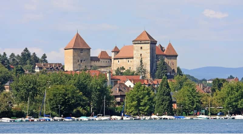 View of Chateau d'Annecy. The Chateau d'Annecy is a magnificent historical castle perched atop a hill overlooking the town of Annecy. Its imposing stone walls and turrets harken back to the medieval era. The castle's picturesque location against the backdrop of the French Alps, along with its beautifully landscaped gardens, adds to its charm.