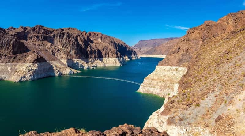  Lake Mead in Arizona. The image showcases the vast expanse of the lake, nestled amidst the arid desert landscape. The surrounding desert hills, adorned with desert flora, frame the lake.