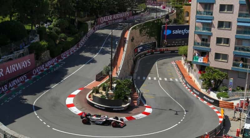 A captivating photograph capturing the exhilarating atmosphere of the Monaco Grand Prix. The image showcases the iconic street circuit winding through the principality's glamorous streets, with Formula 1 cars racing at high speeds.