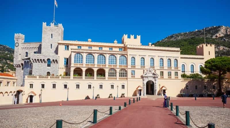 In the image of the Prince's Palace of Monaco in Monaco, France, the iconic palace dominates the landscape, perched majestically atop a rocky promontory. The palace's façade features elegant balconies and grand windows that overlook the scenic panorama, while the flag of Monaco waves proudly in the gentle breeze.