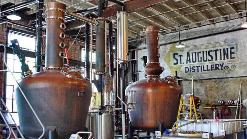 The image displays fermentation vats at a distillery located in Saint Augustine, Florida, USA.