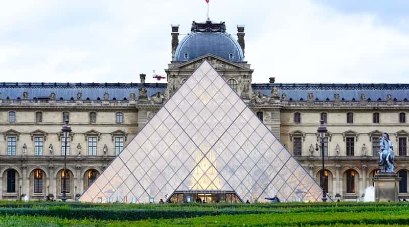A direct view of the Louvre, showcasing the iconic museum building in Paris. The image provides a clear perspective of the Louvre's exterior architecture, featuring its distinctive facade and recognizable structures.