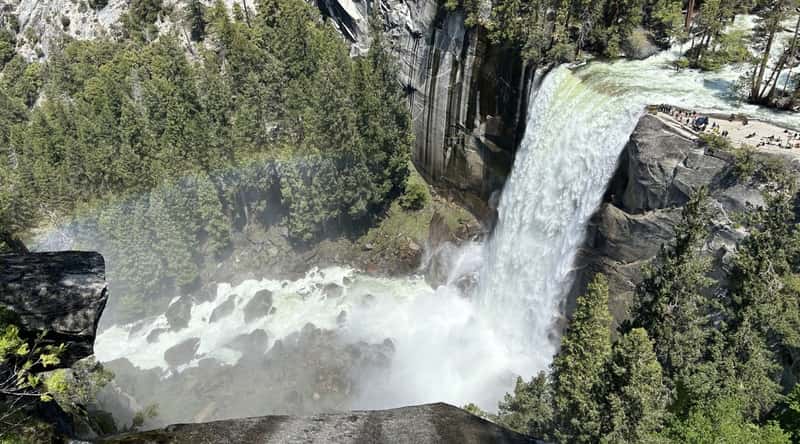 A photograph capturing Vernal Fall in California. The image portrays the waterfall within Yosemite National Park, surrounded by natural rock formations and lush vegetation.