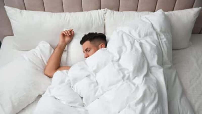 Man sleeping under soft blanket