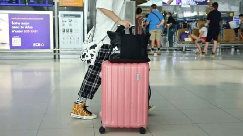 Holiday, luggage and customs with passenger in line for airline ticket, departure and flight transportation