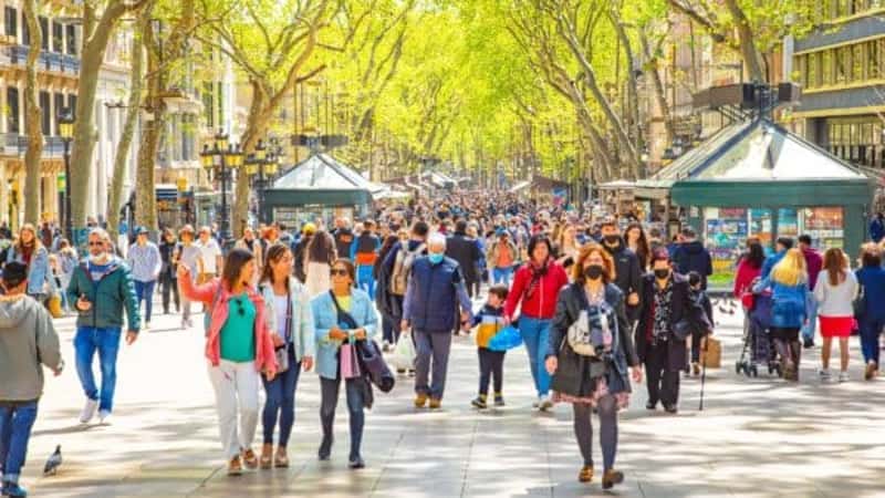 La Rambla busy street photo with many walking people. La Rambla is the most popular pedestrian street in Barcelona city.La Rambla busy street photo with many walking people. La Rambla is the most popular pedestrian street in Barcelona city.
