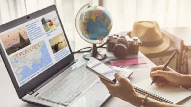 Young woman planning vacation trip and searching information or booking an hotel on a smart phone and laptop, Travel plan concept