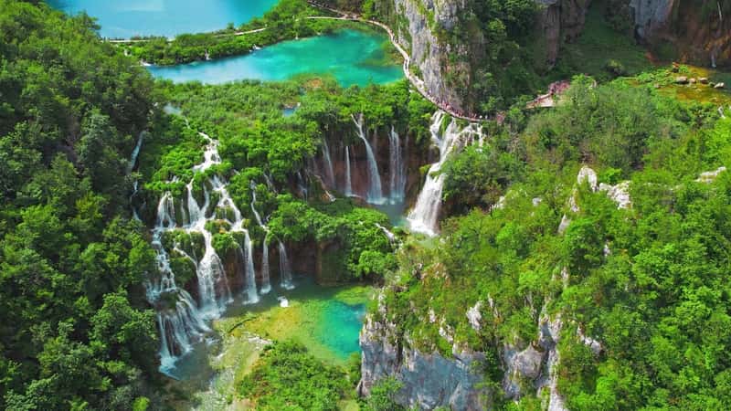 Plitvice Lakes and waterfalls in National Park Croatia. Summer mountain landscape with streams, emerald green water.