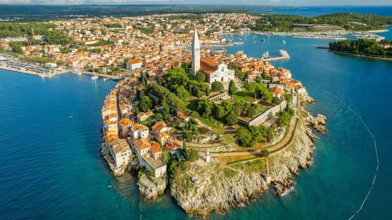 Aerial view of the Rovinj old town at sunset, famous ancient Croatian city at the Adriatic sea, Istria peninsula, Croatia. Rovinj cityscape, cathedral of St. Euphemia and historic buildings