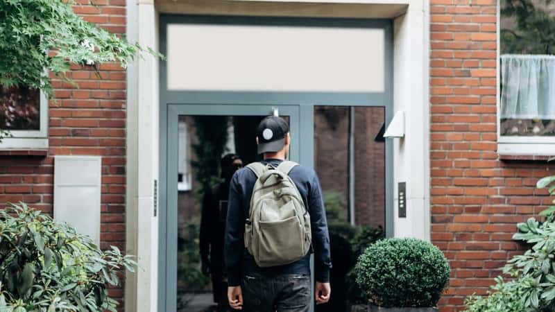 A tourist goes to the guesthouse or hostel in order to stay in a room that he booked.