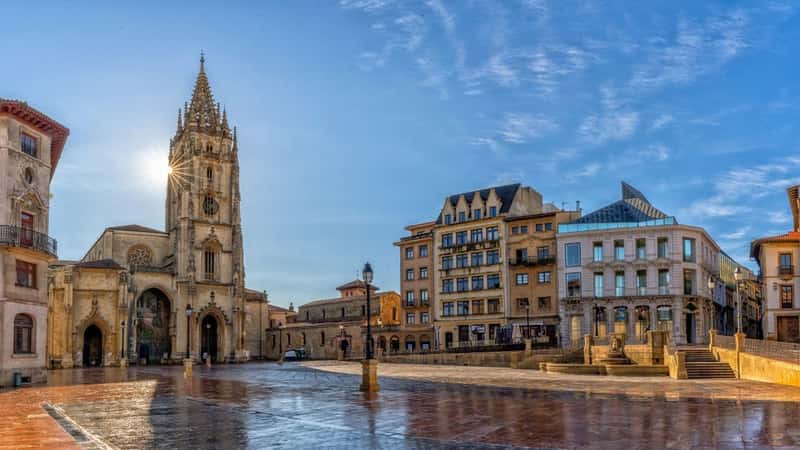 Oviedo, Spain - 24 April, 2022: panorama view of the San Salvador Cathedral and square in the historic city center of Oviedo with a sunburst