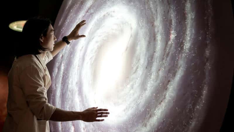 Man experiencing the universe at a planetarium